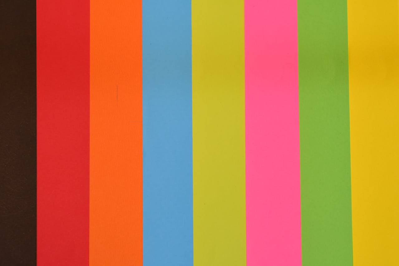 A vibrant striped background featuring various colors such as red, orange, and blue.